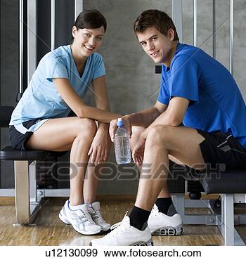 Stock Photograph - two friends sitting 
in a gym. fotosearch 
- search stock 
photos, pictures, 
images, and photo 
clipart