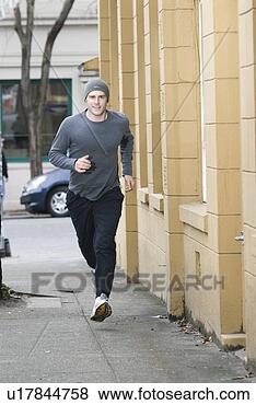 Stock Photo - young man jogging. 
fotosearch - search 
stock photos, 
pictures, images, 
and photo clipart