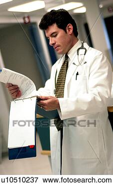 Picture - doctor looking 
at patient chart 
doctor looking 
at patient chart. 
fotosearch - search 
stock photos, 
pictures, images, 
and photo clipart