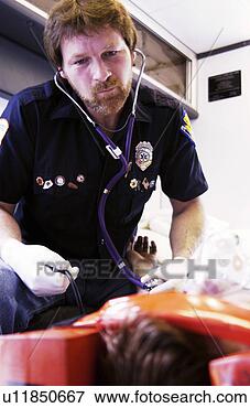 Picture - emt working on 
patient on stretcher. 
fotosearch - search 
stock photos, 
pictures, images, 
and photo clipart
