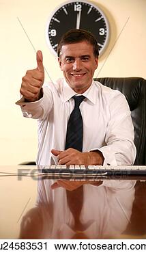 Stock Photography - businessman sitting 
at desk and  making 
a thumbs up gesture. 
fotosearch - search 
stock photos, 
pictures, images, 
and photo clipart