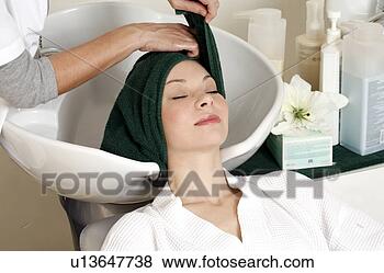 Stock Photo - young woman  having 
her hair  washed 
at a salon. fotosearch 
- search stock 
photos, pictures, 
images, and photo 
clipart