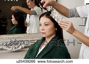 Stock Photo - young woman  having 
her hair  colored. 
fotosearch - search 
stock photos, 
pictures, images, 
and photo clipart