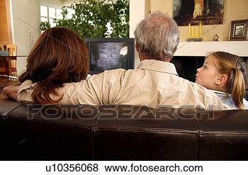 Stock Photo - mature couple 
watching television 
with young girl. 
fotosearch - search 
stock photos, 
pictures, images, 
and photo clipart