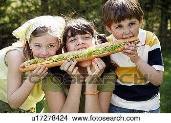 Stock Photo - three children 
sharing a large 
sandwich. fotosearch 
- search stock 
photos, pictures, 
images, and photo 
clipart