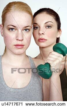Stock Photography - two young women 
with dumbbell. 
fotosearch - search 
stock photos, 
pictures, images, 
and photo clipart