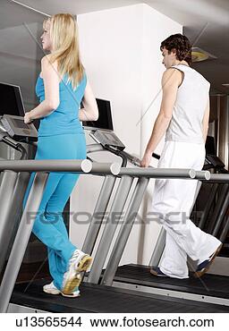 Stock Photo - young woman and 
man on treadmill. 
fotosearch - search 
stock photos, 
pictures, images, 
and photo clipart