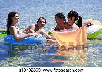 Stock Photo - group of friends 
playing in the 
water. fotosearch 
- search stock 
photos, pictures, 
images, and photo 
clipart