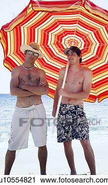 Stock Photography - two men on beach 
with beach umbrella. 
fotosearch - search 
stock photos, 
pictures, images, 
and photo clipart