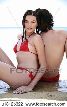 Stock Photo - young couple back 
to back on beach. 
fotosearch - search 
stock photos, 
pictures, images, 
and photo clipart