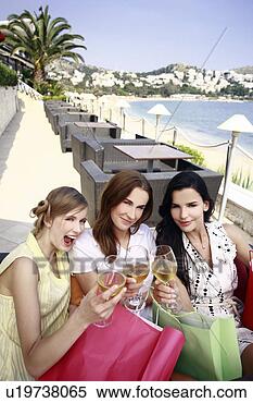 Stock Image - three women with 
shopping bags 
and wine posing. 
fotosearch - search 
stock photos, 
pictures, images, 
and photo clipart