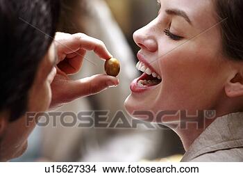 Stock Photo - man feeding woman 
an olive. fotosearch 
- search stock 
photos, pictures, 
images, and photo 
clipart