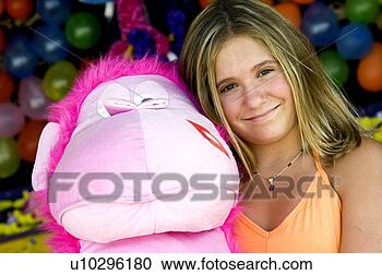 Stock Photography - girl at carnival 
holding stuffed 
animal. fotosearch 
- search stock 
photos, pictures, 
images, and photo 
clipart