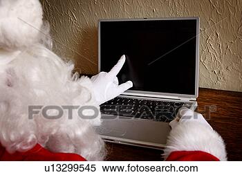 Stock Image - santa with laptop. 
fotosearch - search 
stock photos, 
pictures, images, 
and photo clipart