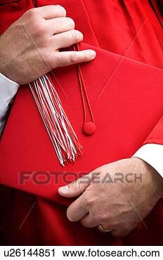 Stock Photography - graduate holding 
cap. fotosearch 
- search stock 
photos, pictures, 
images, and photo 
clipart