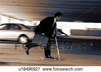 Picture - businessman on 
scooter in parking 
lot. fotosearch 
- search stock 
photos, pictures, 
images, and photo 
clipart