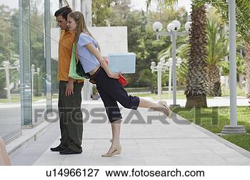 Picture - couple with shopping 
bags looking at 
shop window. fotosearch 
- search stock 
photos, pictures, 
images, and photo 
clipart