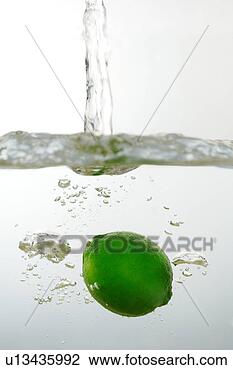 Stock Photo - lemon falling 
in water, surface 
view, close-up. 
fotosearch - search 
stock photos, 
pictures, images, 
and photo clipart