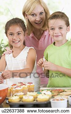 Kitchen Wall Decorations Kids on Photo Of Woman With Two Children In Kitchen Decorating Cookies Smiling