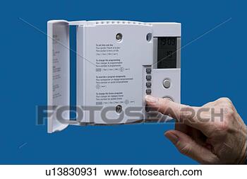 Stock Photography - hand changing 
thermostat. fotosearch 
- search stock 
photos, pictures, 
images, and photo 
clipart