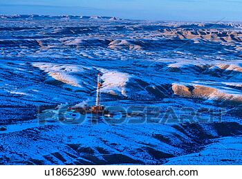 Stock Photography - onshore oil drilling 
rig in mountainous 
snow covered terrain. 
fotosearch - search 
stock photos, 
pictures, images, 
and photo clipart