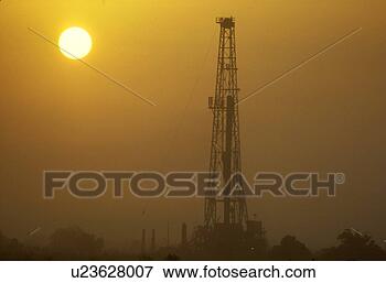 Picture - onshore oil drilling 
rig silhouette 
and sun. fotosearch 
- search stock 
photos, pictures, 
images, and photo 
clipart