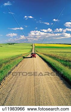 Stock Photo - country road through 
farmland, tiger 
hills, manitoba, 
canada. fotosearch 
- search stock 
photos, pictures, 
images, and photo 
clipart