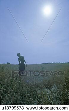 Stock Photo - a dancer posing 
outdoors in front 
of the sun. fotosearch 
- search stock 
photos, pictures, 
images, and photo 
clipart