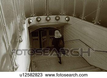 Stock Photo - image of a woman 
walking into a 
subway entrance, 
 high angle view. 
fotosearch - search 
stock photos, 
pictures, images, 
and photo clipart