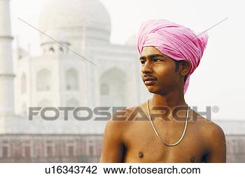 Stock Photo - close-up of a 
young man in front 
of a mausoleum, 
 taj mahal,  agra. 
fotosearch - search 
stock photos, 
pictures, images, 
and photo clipart