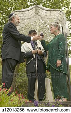 Stock Images of Wedding ceremony under a canopy with Rabbi, bride...