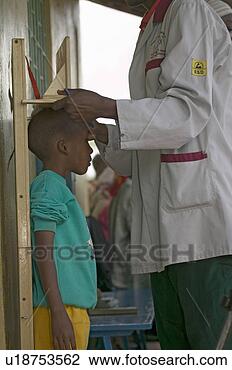Stock Photo - young boy with 
hiv/aids is measured 
at the pepo la 
tumaini jangwani. 
fotosearch - search 
stock photos, 
pictures, images, 
and photo clipart