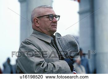 Stock Photography - man covering heart 
with hat, arlington 
national cemetery. 
fotosearch - search 
stock photos, 
pictures, images, 
and photo clipart