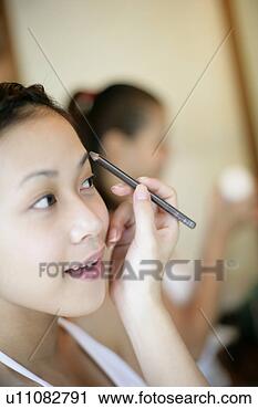 Stock Photography - view of a woman 
applying cosmetic. 
fotosearch - search 
stock photos, 
pictures, images, 
and photo clipart