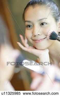 Stock Image - view of a young 
woman doing makeup. 
fotosearch - search 
stock photos, 
pictures, images, 
and photo clipart