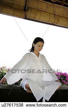 Stock Photo - view of a woman 
sitting with cross 
legged. fotosearch 
- search stock 
photos, pictures, 
images, and photo 
clipart