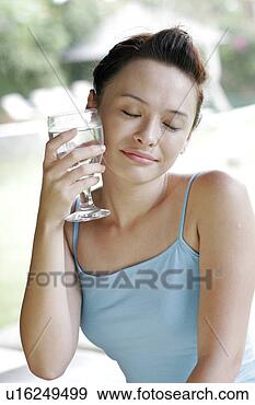 Stock Photograph - view of a young 
woman holding 
goblet. fotosearch 
- search stock 
photos, pictures, 
images, and photo 
clipart