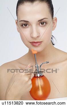 Stock Photography - close-up of a 
young woman holding 
perfume bottle. 
fotosearch - search 
stock photos, 
pictures, images, 
and photo clipart