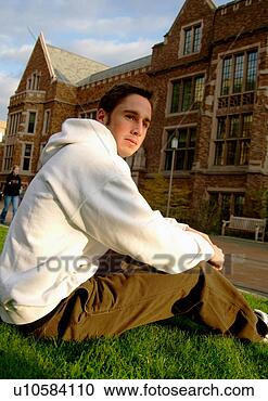 Stock Photography - view of a young 
man relaxing on 
a lawn. fotosearch 
- search stock 
photos, pictures, 
images, and photo 
clipart