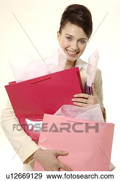 Stock Photograph - portrait of a 
trendy young woman 
carrying shopping 
bags. fotosearch 
- search stock 
photos, pictures, 
images, and photo 
clipart