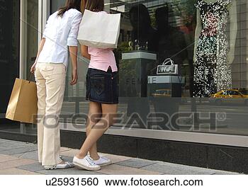 Stock Photography - two friends looking 
at display case. 
fotosearch - search 
stock photos, 
pictures, images, 
and photo clipart
