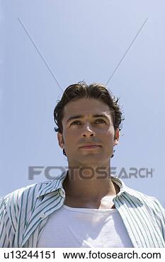 Stock Photography - young adult man 
looking away, 
low angle view. 
fotosearch - search 
stock photos, 
pictures, images, 
and photo clipart