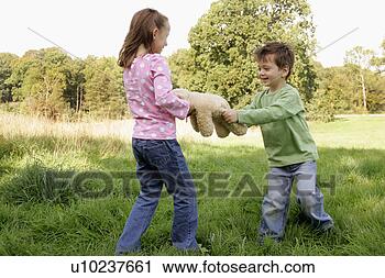 Stock Photography - siblings fighting 
over a teddy bear. 
fotosearch - search 
stock photos, 
pictures, images, 
and photo clipart