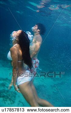 Stock Photo - a mid adult couple 
underwater. fotosearch 
- search stock 
photos, pictures, 
images, and photo 
clipart