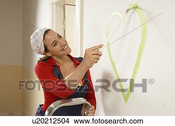 Stock Photo - young woman painting 
a heart on a wall. 
fotosearch - search 
stock photos, 
pictures, images, 
and photo clipart