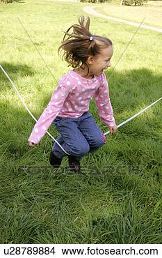 Stock Photo - a young girl jumping 
over a skipping 
rope. fotosearch 
- search stock 
photos, pictures, 
images, and photo 
clipart