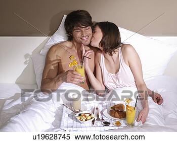 Stock Image - couple having 
breakfast in bed. 
fotosearch - search 
stock photos, 
pictures, images, 
and photo clipart