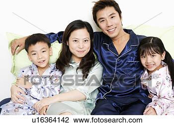 Stock Photo - portrait of a 
mid adult man 
with a young woman 
and their children. 
fotosearch - search 
stock photos, 
pictures, images, 
and photo clipart