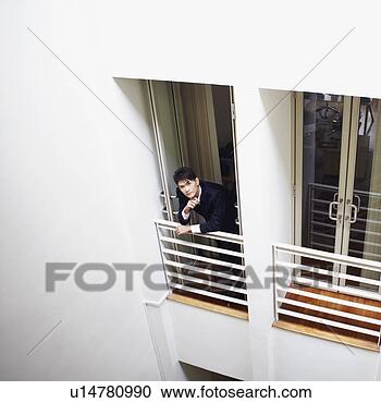 Stock Photography - high angle view 
of a businessman 
standing at the 
doorway in an 
office. fotosearch 
- search stock 
photos, pictures, 
images, and photo 
clipart
