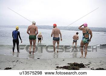 Stock Photo - view of swimmers 
walking towards 
sea. fotosearch 
- search stock 
photos, pictures, 
images, and photo 
clipart